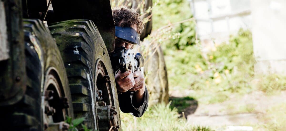 man schiet airsoft achter twee grote banden